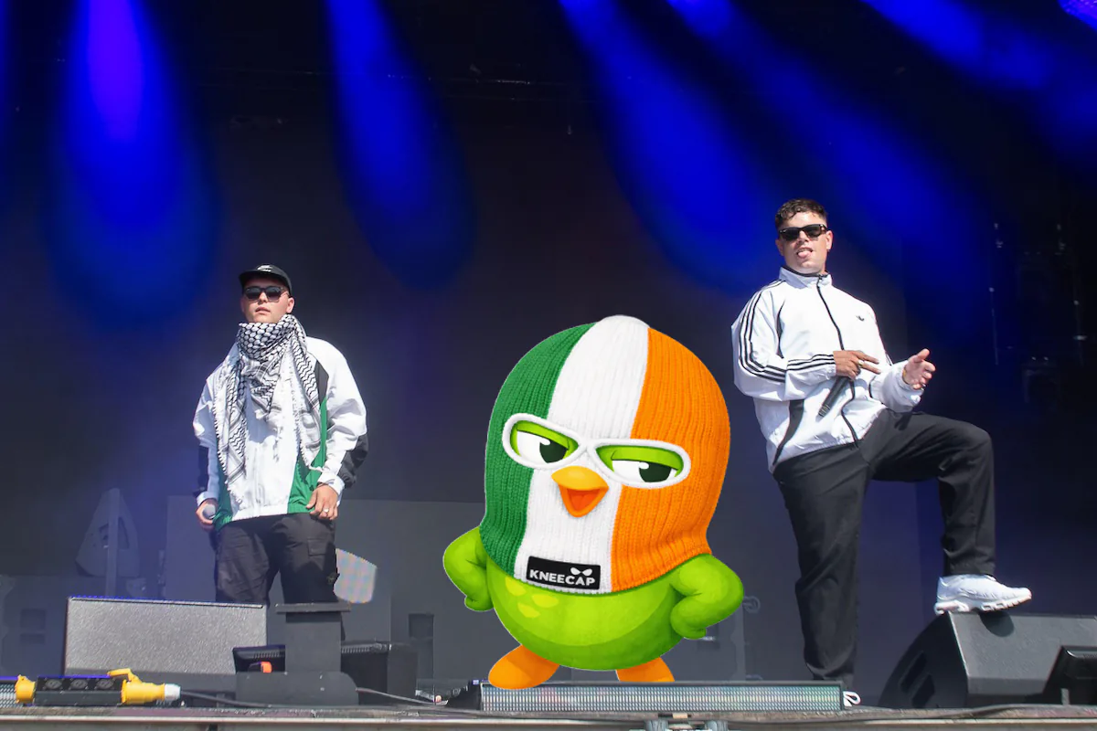 Kneecap on stage with Duo in an Irish-flag balaclava