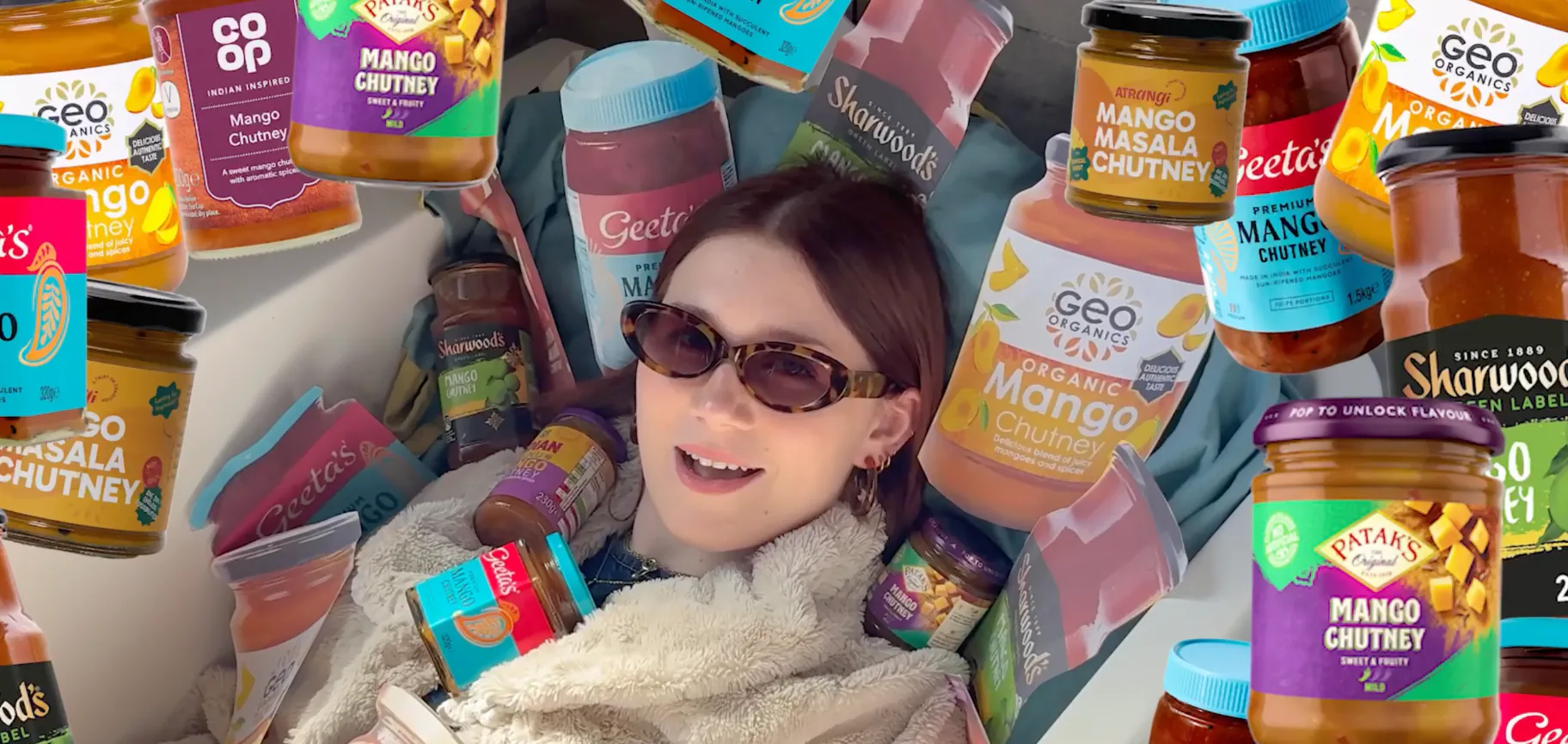 Megan surrounded by jars of mango chutney