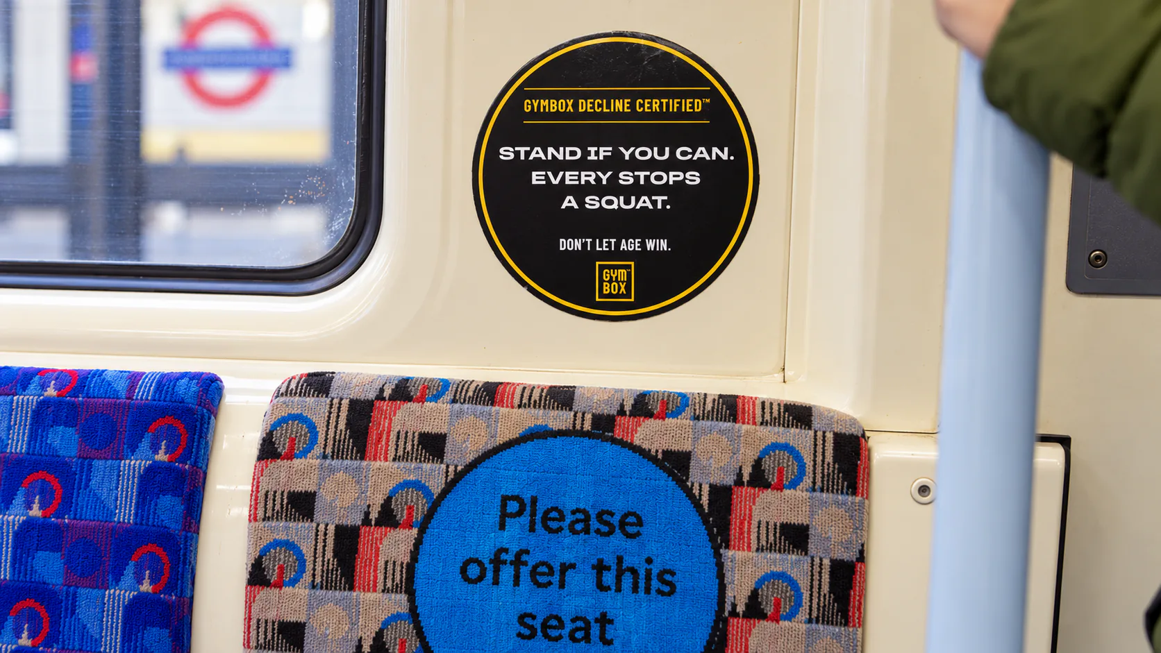 Gymbox Decline Certified sticker above a tube seat: Stand if you can. Every stop’s a squat.